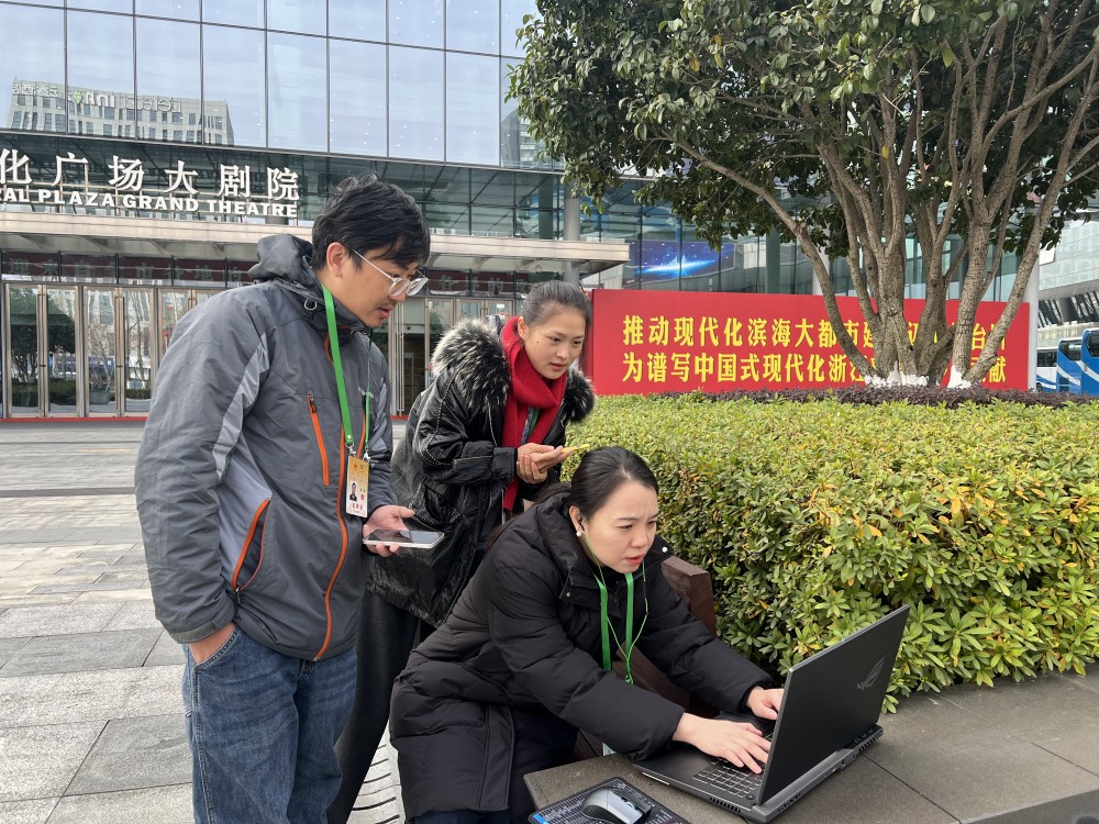 民生中心记者在会场外紧张工作.jpg